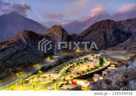 High angle view of the illuminated Thee Ain Park surrounded by the Sarawat Mountains at twilight in Al Bahah, Saudi Arabia High angle view of the illuminated Thee Ain Park surrounded by the Sarawat Mountains at twilight in Al Bahah, Saudi Arabia 138539334