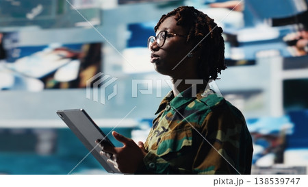 Intelligence agency professional scanning enemy rockets using tablet app. Military operator using radar systems on device to detect incoming ballistic missiles, serving country, camera B 138539747