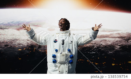 Astronaut wearing space suit amazed by glowing horizon seen from space shuttle cockpit. Woman mesmerized by outer space rotating with arms wide open, concept of planetary discovery, camera A Astronaut wearing space suit amazed by glowing horizon seen from space shuttle cockpit. Woman mesmerized by outer space rotating with arms wide open, concept of planetary discovery, camera A 138539754