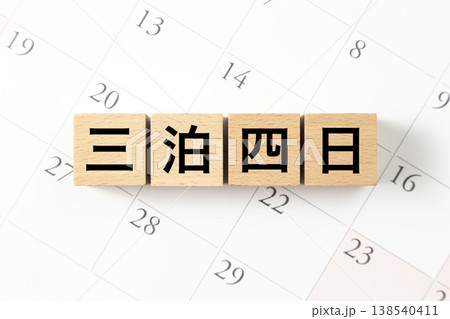 「三泊四日」と書かれたブロックとカレンダー 138540411