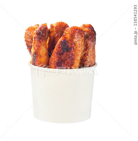 fried chicken wings in a paper bucket isolated on white background. fried chicken wings in a paper bucket isolated on white background. 138541293