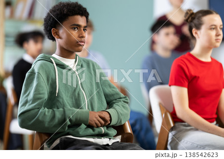 African American teen boy attendee group class and listen to lecturer. 138542623