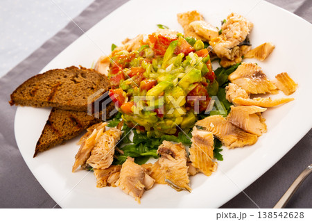 Salad from avocado, tomatoes and greens with trout Salad from avocado, tomatoes and greens with trout 138542628