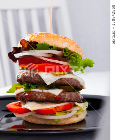 Tasty double-decker grilled burger with beef, tomato, cheese 138542868