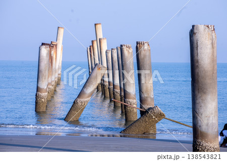 The Leaning pole at Sao Aiang Beach- Derelict concrete pier posts in the seaOld concrete pillars from an abandoned fishing pier, sticking out of the sea The Leaning pole at Sao Aiang Beach- Derelict concrete pier posts in the seaOld concrete pillars from an abandoned fishing pier, sticking out of the sea 138543821