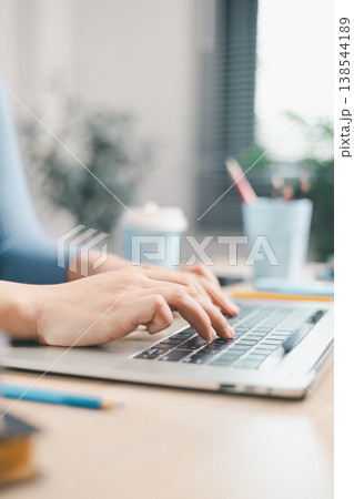 Close up of woman typing on laptop keyboard at home desk. Remote work, online learning, digital communication, productivity and modern workspace lifestyle concept for business and study. Close up of woman typing on laptop keyboard at home desk. Remote work, online learning, digital communication, productivity and modern workspace lifestyle concept for business and study. 138544189