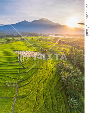Beautiful morning view in Indonesia, panoramic landscape of rice fields with mountain ranges and clear sky Beautiful morning view in Indonesia, panoramic landscape of rice fields with mountain ranges and clear sky 138544262