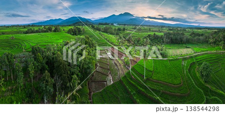 Beautiful morning view in Indonesia, panoramic landscape of rice fields with mountain ranges and clear sky Beautiful morning view in Indonesia, panoramic landscape of rice fields with mountain ranges and clear sky 138544298