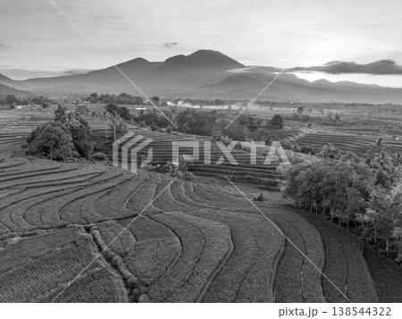 Beautiful morning view in Indonesia, panoramic landscape of rice fields with mountain ranges and clear sky 138544322