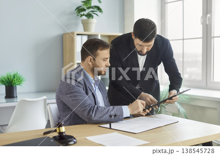 Male lawyer having a meeting with a client and discussing contract in the office. 138545728