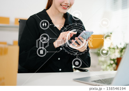 Woman hand using a laptop, smartphone and tablet and writing notebook at the office of her business online shopping. In home with virtual icon 138546194