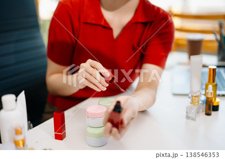 Asian beauty influencer reviewing lipstick and cosmetics on camera for online marketing and ecommerce, reflecting modern lifestyle content creation Asian beauty influencer reviewing lipstick and cosmetics on camera for online marketing and ecommerce, reflecting modern lifestyle content creation 138546353