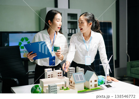 Business team meeting for ESG, net zero, and sustainability goals. Green energy, climate action, and eco-friendly strategies with globe Business team meeting for ESG, net zero, and sustainability goals. Green energy, climate action, and eco-friendly strategies with globe 138546772