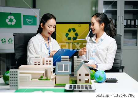 Business professionals presenting sustainable city model with renewable energy, solar panels and wind turbine, green business, ESG, smart city 138546790