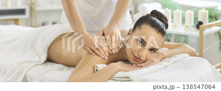 Relaxing back massage at spa clinic with therapist and candles, wellness care Relaxing back massage at spa clinic with therapist and candles, wellness care 138547064
