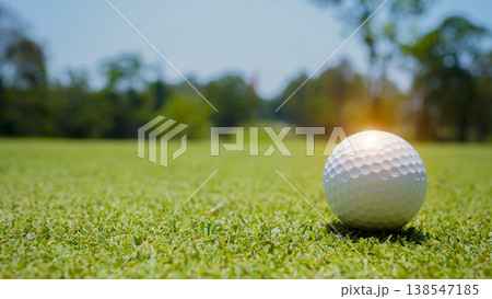 Golf ball is on a green lawn in a beautiful golf course with morning sunshine. Golf ball is on a green lawn in a beautiful golf course with morning sunshine. 138547185