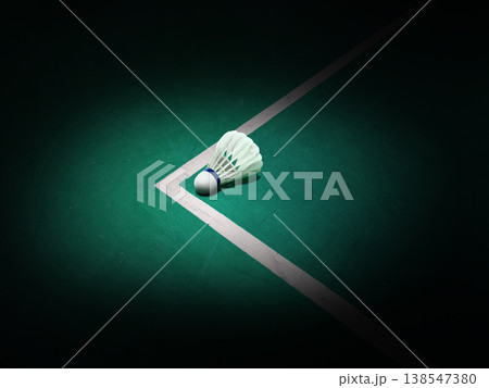 A white badminton shuttlecock is placed on the badminton court against a black background. 138547380
