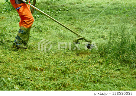 Park summer work.Grass cutting with handle lawn mower  138550055