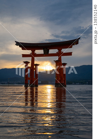Famous red torii gate of Itsukushima shrine at sunset in Miyajima, Japan 138552140