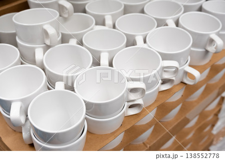 White cups and mugs in crockery shop, ceramic dishware, tableware stack in store White cups and mugs in crockery shop, ceramic dishware, tableware stack in store 138552778
