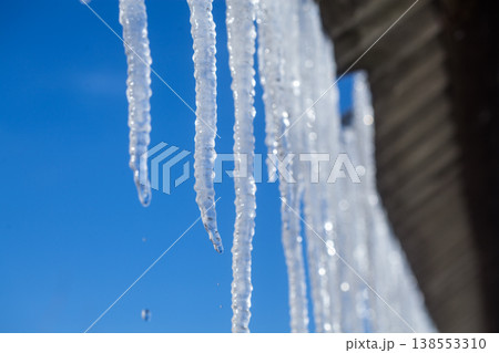 Long natural icicles on a sky background 138553310