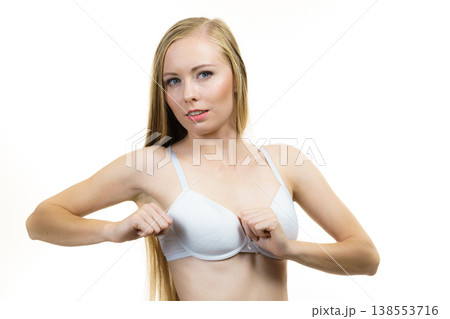 Woman wearing too big bra 138553716