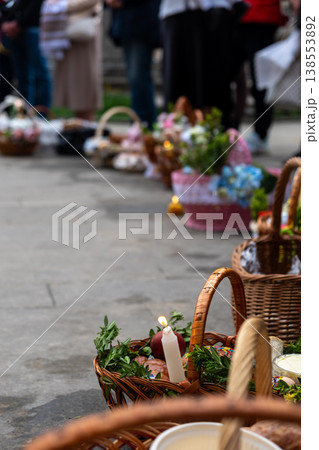 Easter food baskets with candles and flowers at blessing ceremony Easter food baskets with candles and flowers at blessing ceremony 138553892