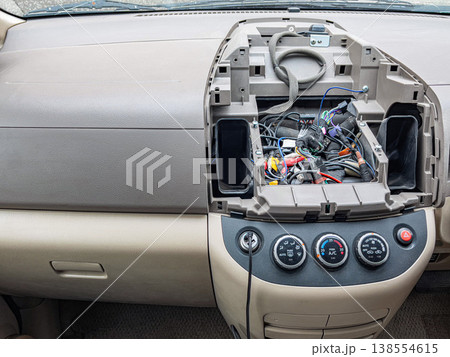 Technician carefully examines vehicle electronic components using advanced calibration and measurement tools 138554615