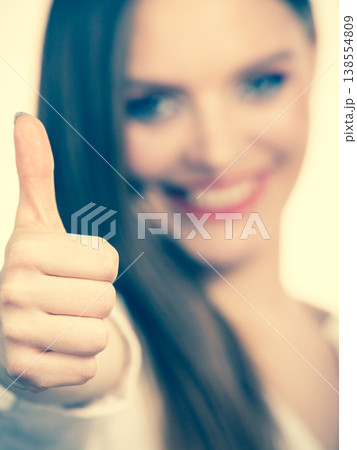 Happy positive brunette woman showing thumb up Happy positive brunette woman showing thumb up 138554809