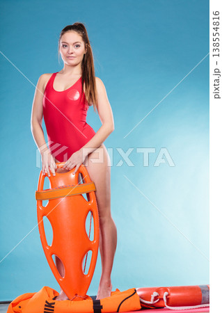 Lifeguard with rescue buoy supervising. 138554816