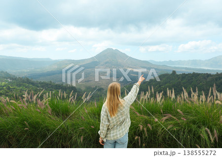 A person points at Mount Batur in Kintamani Bali A person points at Mount Batur in Kintamani Bali 138555272