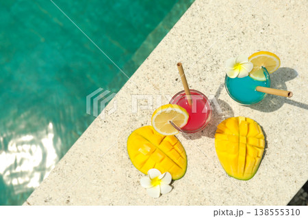 Drinks and mango slices are placed by the pool in Bali Drinks and mango slices are placed by the pool in Bali 138555310
