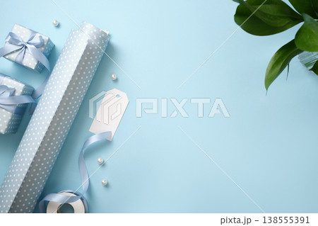 Festive background with blue wrapping paper, a label, a ribbon and presents. Copy space Festive background with blue wrapping paper, a label, a ribbon and presents. Copy space 138555391