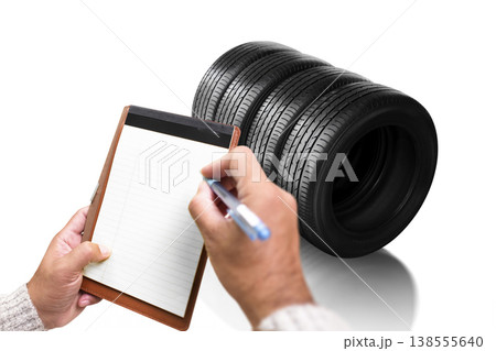 Tire Inventory Inspection, A person writes on a blank notepad while checking Tire Inventory Inspection, A person writes on a blank notepad while checking 138555640