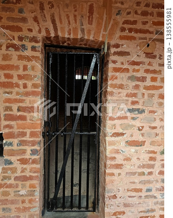 Andaman and Nicobar Islands , 29th May 2024 A weathered red brick wall and heavy iron-barred door of a solitary confinement cell at the historic Cellular Jail in Port Blair. Andaman and Nicobar Islands , 29th May 2024 A weathered red brick wall and heavy iron-barred door of a solitary confinement cell at the historic Cellular Jail in Port Blair. 138555981