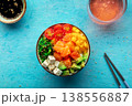 Salmon poke bowl with mango, avocado, tofu, wakame, overhead shot 138556887