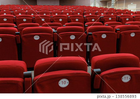 auditorium of cinema or theater. Empty rows of red velvet armchairs filling auditorium. auditorium of cinema or theater. Empty rows of red velvet armchairs filling auditorium. 138556893