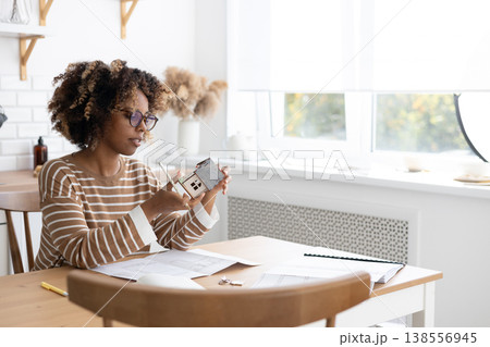 female architect or realtor holds mock up of house in her hands, deals with planning. female architect or realtor holds mock up of house in her hands, deals with planning. 138556945