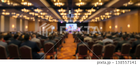 Blurred Photo of a Large Conference Hall with Audience Blurred Photo of a Large Conference Hall with Audience 138557141