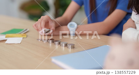 Child counting coins for financial education 138557229