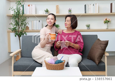 Mother and daughter bonding over knitting and tea 138557661