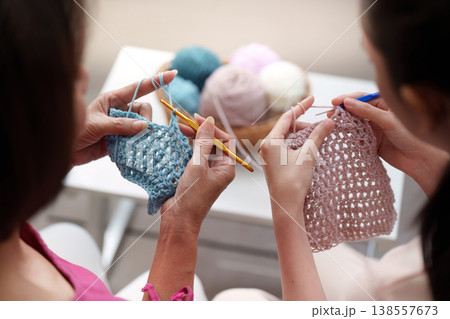 Mother and daughter knitting together on Mother's Day 138557673