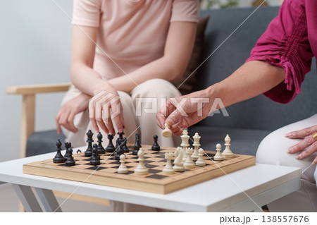 Mother and daughter playing chess on Mother's Day Mother and daughter playing chess on Mother's Day 138557676