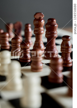 Wooden chess pieces on chessboard for strategy game Wooden chess pieces on chessboard for strategy game 138558880