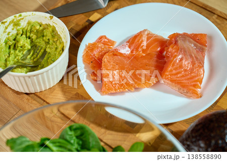 Healthy Breakfast Ingredients with Salmon, Avocado and Greens on Cutting Board 138558890