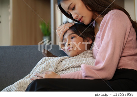 Mother caring for her sick child at home 138558959