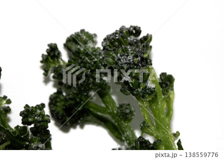 Close up of purple sprouted broccoli blanched on white background Close up of purple sprouted broccoli blanched on white background 138559776