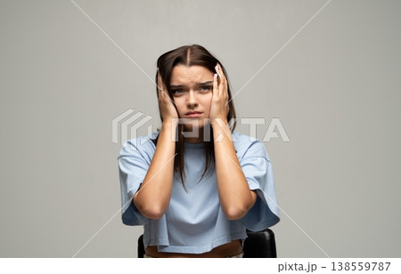 Young woman covering ears, experiencing stress, anxiety, tension, headache or mental health issues Young woman covering ears, experiencing stress, anxiety, tension, headache or mental health issues 138559787