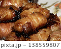 Close up of chipolatas pigs in blankets sausages wrapped in bacon on white background 138559807