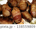 Close up of chipolatas pigs in blankets sausages wrapped in bacon on white background 138559809